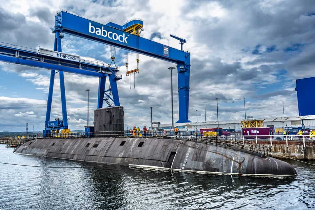 Swiftsure submarine in dock at Rosyth, beneath blue Babcock crane